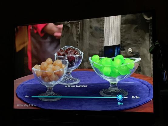 A table with 3 bowls of sweeties on it. From left to right toffee coloured round Hawick Balls, burgundy-brown Jethart Snails, and luridly bright green round Soor Plooms from Galashiels.