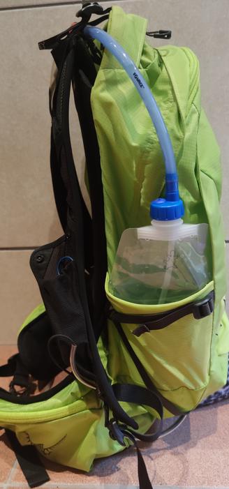 A Platypus soft bottle is connected to a hydration pipe and is in the sidepocket of a daypack.