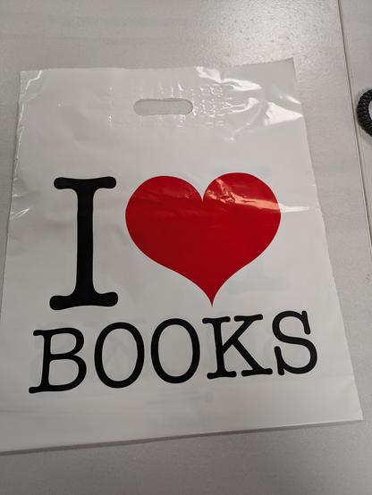 A white plastic bag that reads, “ I heart books.”