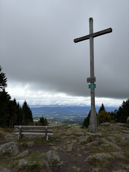 The cross at the summit of Pröller with dark clouds in the background
