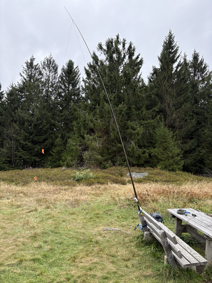 A portable amateur radio station on a table in front of trees