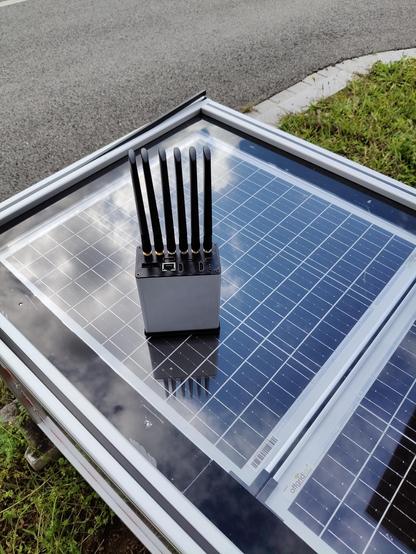 A V2X node placed on top of a solar panel.