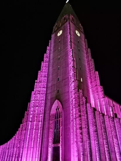 Le clocher de l'église, coloré en rose par des protecteurs situés au sol.