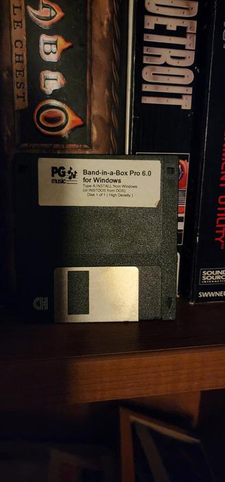 A the foreground is a floppy disk that contains Band in a box pro version six for windows and dos. In the background is the Diablo battle chest and detroit