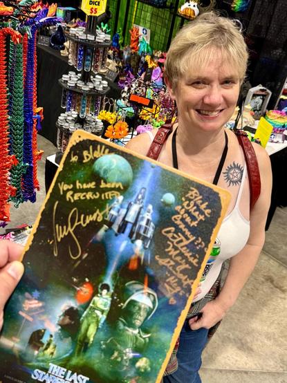 The Last Starfighter poster signed by Lance Guest and Catherine Mary Stewart, with my wife in the background