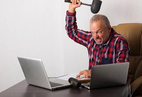 Someone who is definitely not me about to smash a laptop with a mallet