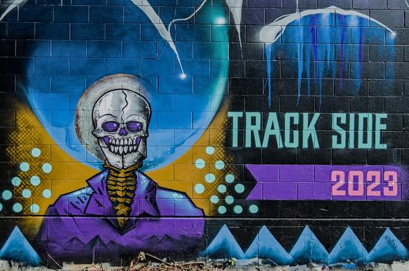 Mural announcing track side street art event