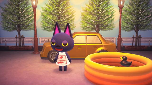 Animal Crossing: New Horizons screenshot. Image shows an outdoor-like setting with trees in the background and two streetlamps visible. Kiki is wearing a custom white dress with two red outlined eyes in rectangles stacked vertically. She is standing in front of a yellow / golden luxury car with an orange kiddie pool next to her.