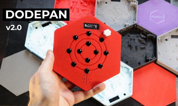 A portable music instrument in front of several 3D-printed enclosures
