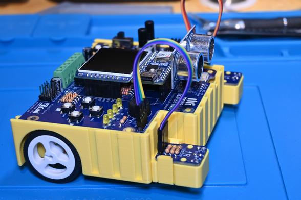 Right front view of a yellow 3D-printed BEAPER Bot robot controlled by an Arduino Nano ESP32-base BEAPER Nano circuit.