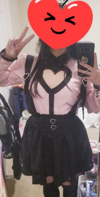 Pink top with hear cut out at chest and black suspender skirt