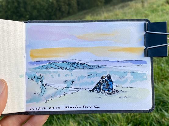 A coloured sketch of a couple watching the sun rise above a green landscape.