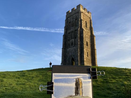 The Tower on Glastonbury Tor and a coloured Sketch of it in front.
