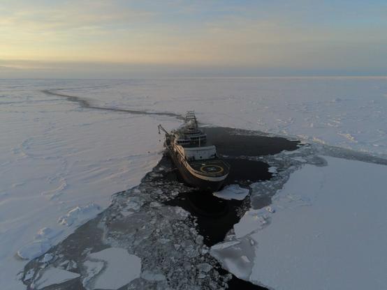An aerial photo of Norway's research icebreaker, FF Kronprins Haakon, in sea ice. Somewhere in the Arctic Ocean, September 2022.
