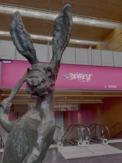 Statue in the venue, with DevFest logo in the background
