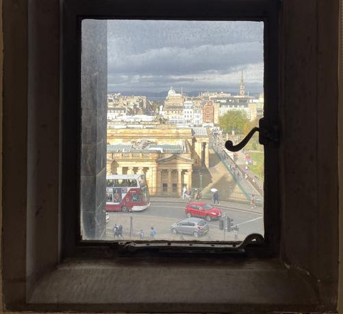 view from a window in new college edinburgh, down the mound and across to the firth of forth