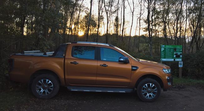 The #PrideOrange #WarMachine #SitsComfortably in front of some #RedundantSignage