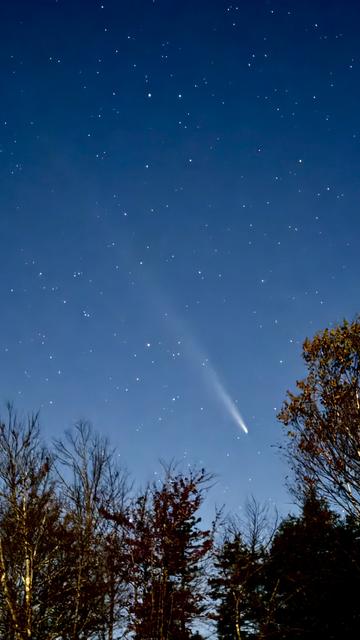 A comet stretches across the night sky