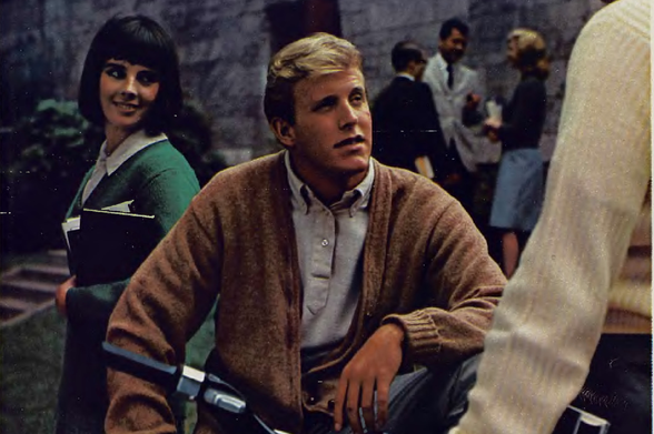 1964 

In the image, we see a group of people engaged in what appears to be an intense conversation.
They are standing and seated around each other with some looking directly at someone or something off-camera.
Tags: vintage clothing, social interaction, 1960s fashion