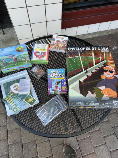 Photo of the board games Envelopes of Cash, Roll In One, Golpher, Sky Towers,  We Need to Talk and Oishii
