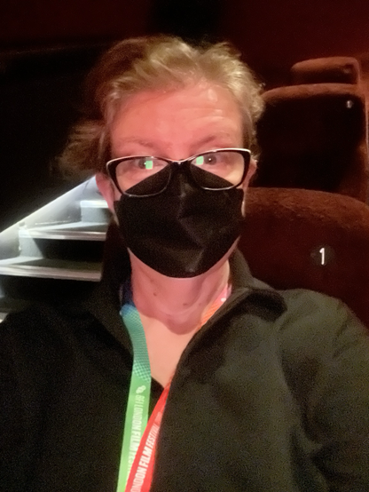 MaryAnn wearing a black FFP2 facemask in screen 1 at Picturehouse Central, waiting for. London Film Festival press and industry screening to begin.