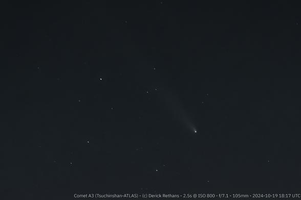 A black sky with some white dots (stars). On the right side of the photo is a bright dot with a fluffy tail sticking out to the north west, the comet A3.

A banner text in the bottom says: Comet A3 (Tsuchinshan-ATLAS) - (c) Derick Rethans - 2.5s @ ISO 800 - f/7.1 - 105mm - 2024-10-19 18:17 UTC