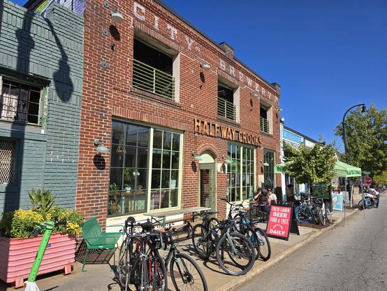 Bikes parked in front of a brick building with a sign saying "Halfway Crooks"