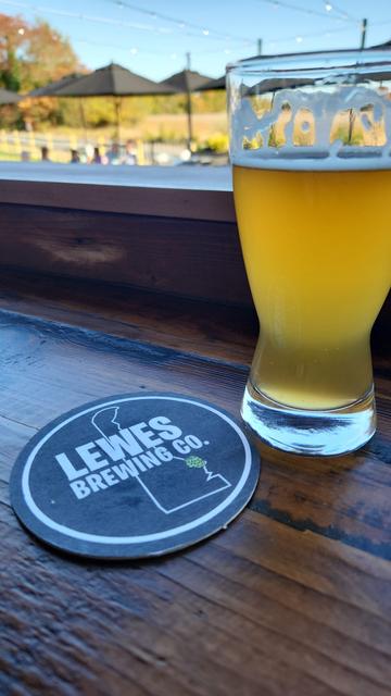 Glass of beer next to Lewes brewing coaster.