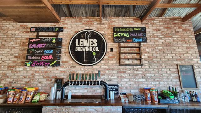 Brick wall with list of Lewes brewing beers.