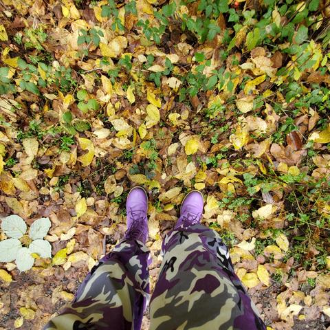 Looking down at my purple camo pants & boots on Autumn leaves covered forest floor.