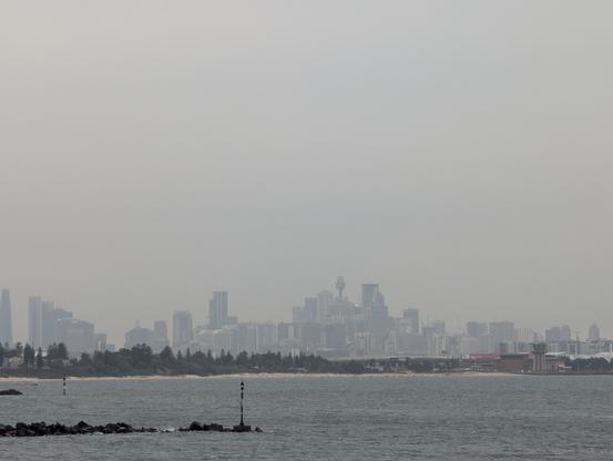 Sydney's metropolitan skyline seen across the bay harbour on a cloudy steamy cool weird kinda day