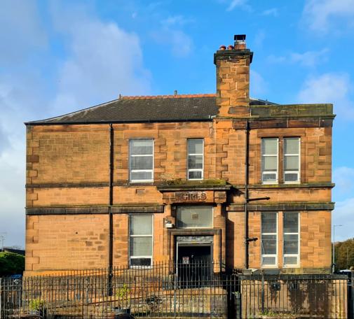 The side entrance to Victorian school marked with the word Girls to indicate it was the girl's entrance.