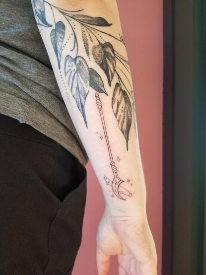 A photo of a tattoo I did yesterday, of a glaive/staff from my "choose your weapon" flash sheet on a client's arm.