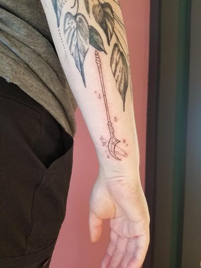 A photo of a tattoo I did yesterday, of a glaive/staff from my "choose your weapon" flash sheet on a client's arm.