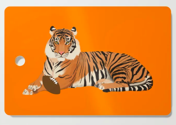Our orange tiger football mascot is shown on a cutting board.