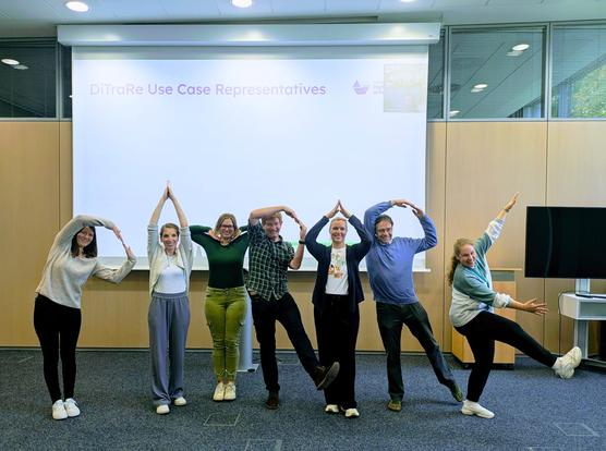 The seven Use Case Representatives if DiTraRe are jokingly trying to form the seven letters DiTraRe with their bodies.