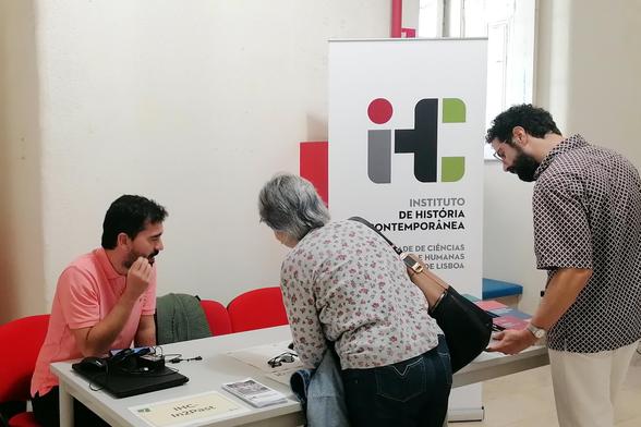 Picture of the IHC's table, where our science manager is speaking with visitors