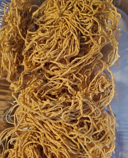 Crispy fried chow mein in aluminum pan