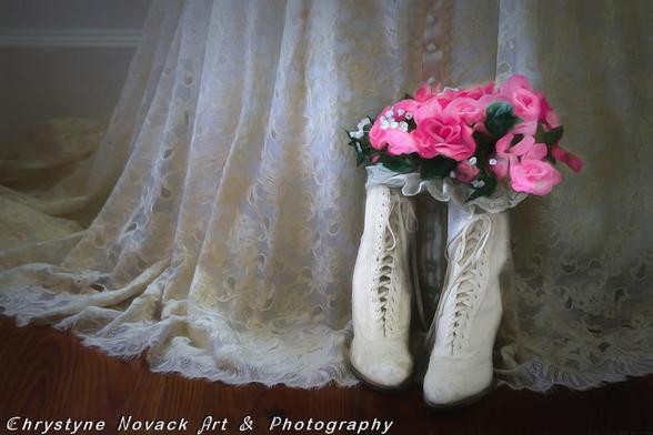 Morning light illuminates the delicate lace of a vintage wedding dress and the lace up boots that cradle a pink floral bouquet that await her special day.

This photo turned painting scene captures a new day dawning as the bridal dress and bouquet awaits the bride to get ready. Sharp eyes will see that there are two heart shapes in the delicate folds of the flower petals.