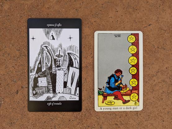 The Eight of Pentacles from the Elsewhere Tarot, showing a rough, sketchy drawing of a  futuristic city with a robed figure floating above it that looks like the ones in the monster’s chest on the Three of Pentacles, alongside the Eight of Pentacles from a janky, bootleg RWS deck, showing a craftsman engraving pentacles into gold coins.