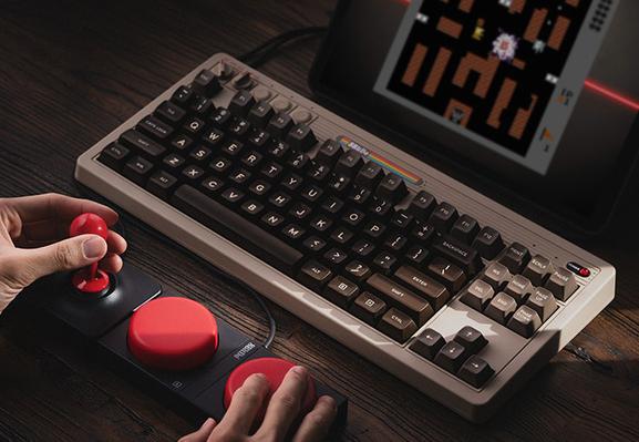 8bitdo's Commodore 64-inspired mechanical keyboard with a joystick in front of it.