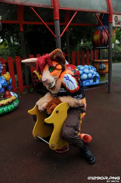 Nurux sitting on a playground spring duck, he looks a bit too large for the toy. Yet is still having fun!