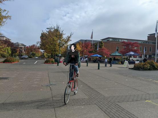 Person riding a red tall bike one the U of O campus