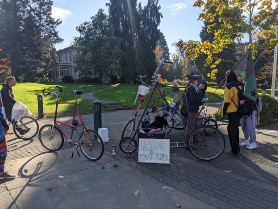 The workshop space featuring 3 tall bikes and a sign that says "ride a tall bike"