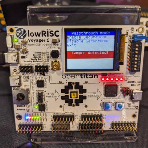 An exposed RISC-V board with a small display screen showing the words: Passthrough Mode. Options to select Enable secureboot, disable secureboot, and exit. below, a line reads, tamper detected!