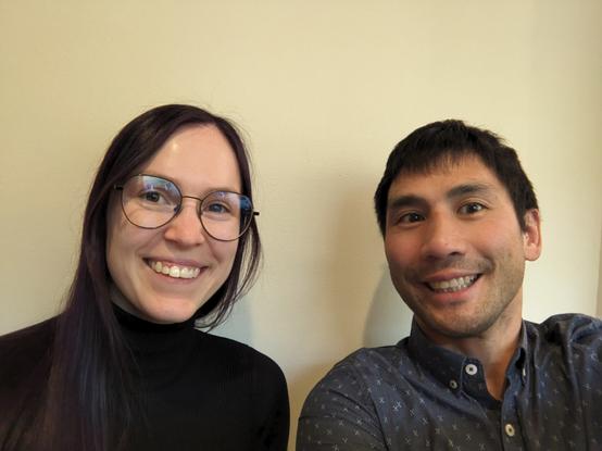 Two computer scientists take a selfie at a conference.