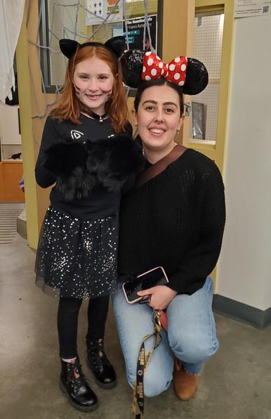 Redhead girl in black cat costume with Sevval in Minnie Mouse ears.