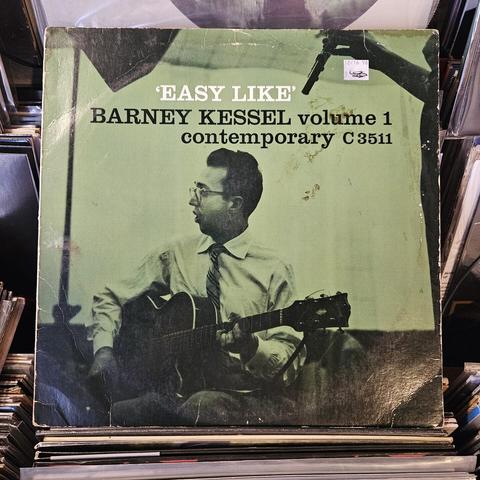 Green album cover features photo of Barney Kessel playing a guitar in the studio.