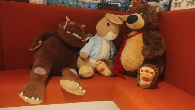 Cuddly Gruffalo, Peter Rabbit and Hugless Douglas teddies slumped together on a seat in the children's room of the Edinburgh Bookshop