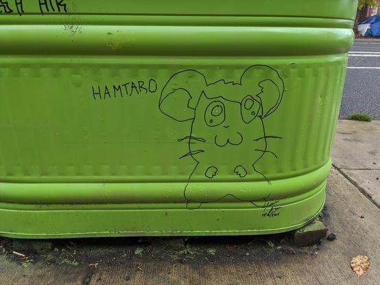 A crudely but cutely drawn reduction of Hamtaro on the side of a large lime green planter